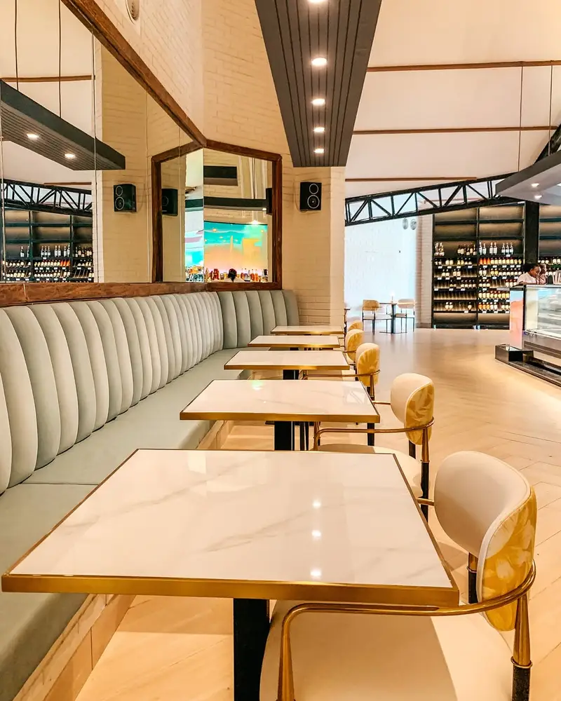 Summer Lounge sage banquette seating beneath the Summer Lounge wall mark